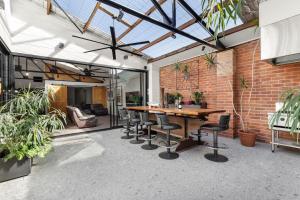 an indoor patio with a wooden table and chairs at Platinum Precinct - The Penthouse in Newcastle