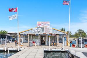 a seafood restaurant on a dock with two flags at Rock Lane Resort & Marina in Branson