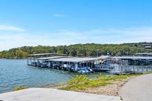 a dock on the water with tables and chairs at Rock Lane Resort & Marina in Branson