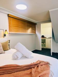 a bedroom with a bed with towels on it at Kurow Motel in Kurow