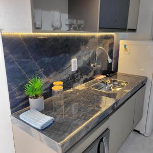 a kitchen with a sink and a counter top at Loft 3 Novo 5 min aeroporto Marabá in Marabá
