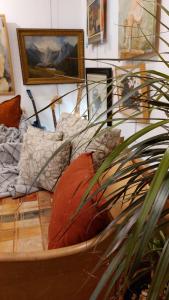 a room with a bed with pillows and a plant at HeArt of Old Town Guesthouse in Podgorica