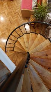 a wooden spiral staircase with a wooden floor at HeArt of Old Town Guesthouse in Podgorica