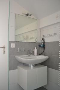 a bathroom with a sink and a mirror at Two-bedroom Apartment for 4-5 guests with lake and mountain views in Emmetten