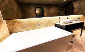 a bathroom with a sink and a mirror at Den Basta hotel in Yangsan +94 photos