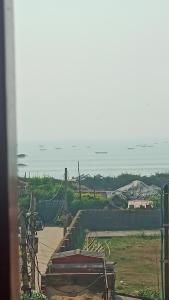 a view of the ocean from a house at SRIKRUTI SEA VIEW in Puri