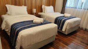 Postel nebo postele na pokoji v ubytování Mamutik Island Lodge
