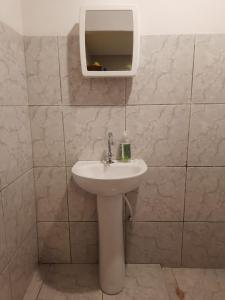 a bathroom with a sink and a mirror at Casa Alto da Falésia in Baía Formosa