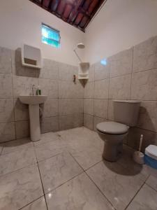 a bathroom with a toilet and a sink at Casa Alto da Falésia in Baía Formosa