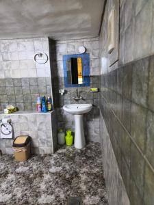 a bathroom with a sink and a toilet and a mirror at Mousa's studio in Jerash