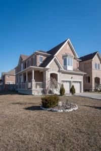 a large house with a large yard in front of it at The Oasis in Bowmanville