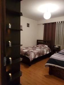 a bedroom with two beds in a room at Apartamentos La Floresta in Cochabamba
