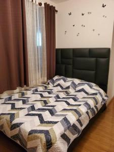 a bedroom with a bed with a quilt on it at Apartamentos La Floresta in Cochabamba
