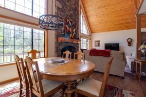 a dining room with a table and a fireplace at Lariat House in Sisters