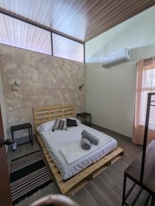 a bedroom with a large bed in a room at Yellow House - Great experience in the country in San Ramón