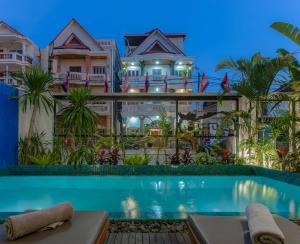 a view of a resort with a swimming pool at Family Style 3-Bedroom Suite by Baahu Villa in Siem Reap