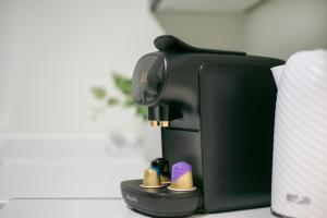 a coffee maker sitting on top of a table at Strawberry Bank Apartment ✪ Grampian Lettings Ltd in Aberdeen