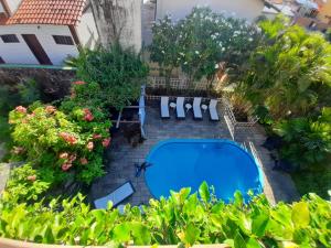 una vista aérea de una piscina con sillas y plantas en Pousada Beijos y Abraços, en Natal