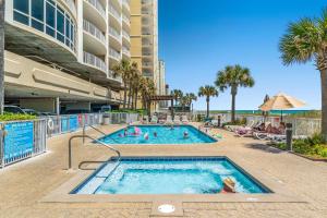 a swimming pool at a resort with people in it at Ocean Villa 1104 in Panama City Beach