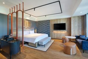 a hotel room with a bed and a tv at Tribe Bali Kuta Beach in Kuta +46 photos