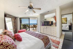a bedroom with a large bed with a view of the ocean at Terrasol Elite Premium Vacation Rentals in Cabo San Lucas