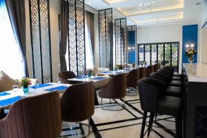 a row of tables and chairs in a restaurant at Savan Resorts in Savannakhet +93 photos