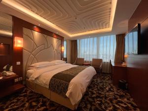 Ένα ή περισσότερα κρεβάτια σε δωμάτιο στο Howard Johnson Paragon Hotel Beijing Centra Provide tourism and ticketing service