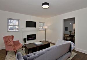 a living room with a couch and a fireplace at The Carolina Wren - Comfort and Convenience in Greenville