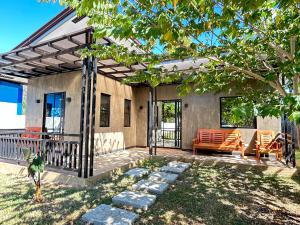 a patio of a house with a table and chairs at Bahay Tanglaw San Jose in Puerto Princesa City
