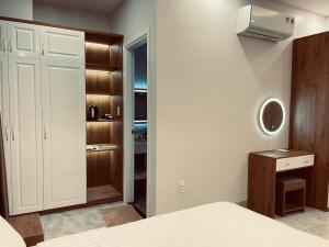 a bedroom with a bed and a closet at Hà Hùng Panorama Hotel in Ha Tien