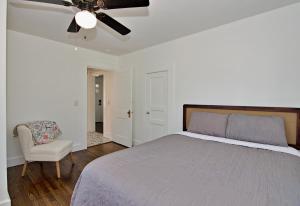 a bedroom with a bed and a ceiling fan at The Carolina Wren - Comfort and Convenience in Greenville