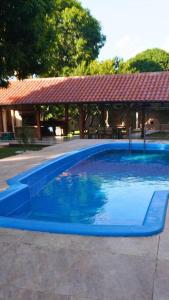a large blue swimming pool with a gazebo at Casa de Campo in Santa Cruz de la Sierra