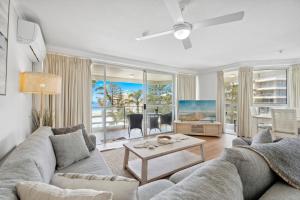 a living room with a couch and a table at Baronnet Apartments in Gold Coast
