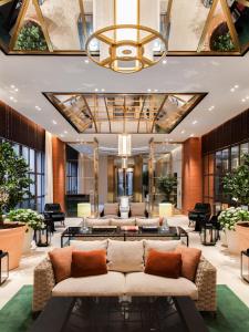 a lobby with couches and tables in a building at Lanson Place Causeway Bay, Hong Kong in Hong Kong