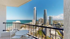 a balcony with a chair and a view of the ocean at Cosy Studio with Stunning Ocean Views DUPLICATE in Gold Coast