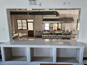 a large kitchen with a large white counter top at Hotel Kilimanjaro - Luanda Angola in Luanda