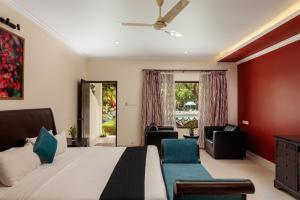 a bedroom with a bed and a living room at Wild Berry Resort Agonda in Canacona +97 photos