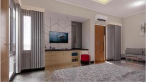 a bedroom with a bed and a flat screen tv at Sumarsi Homestay Mitra RedDoorz in Demangan +5 photos