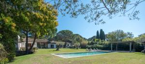 a house with a swimming pool in a yard at Jansson Stars ***** in Saint-Tropez