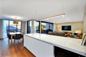 a kitchen and living room with a white counter top at Stunning Apartment in the CBD with Parking & WiFi in Launceston