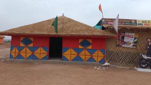 a colorful building with a thatheastern at Road to Haven chandani in Dholovira