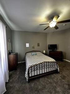 1 dormitorio con 1 cama y ventilador de techo en Renovated,Comfortable and Convenient Experience en Rocky Mount