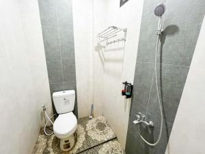 a small bathroom with a toilet and a shower at Reddoorz Near BNS 2 in Tlekung +45 photos