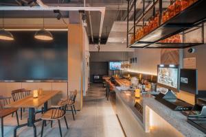 a restaurant with tables and chairs and a bar at Joy Hongqiao Airport and Railway Hotel in Shanghai +17 photos