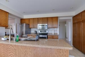 a kitchen with wooden cabinets and a counter top at Lake View House, 30 minutes to Downtown Toronto in Toronto
