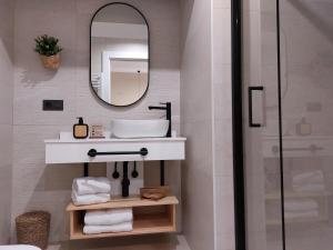 a bathroom with a sink and a mirror at Pensión Cabezas Oviedo in Oviedo