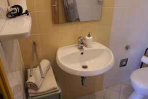 a bathroom with a sink and a toilet at Apartments Ante - 50m from the sea in Posedarje