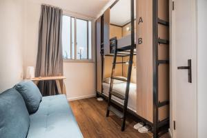a small room with bunk beds and a bed at Joy Hongqiao Airport and Railway Hotel in Shanghai