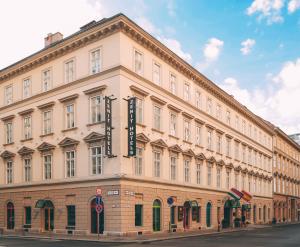 a large building with a sign on the side of it at Hotel Zenit Budapest Palace in Budapest