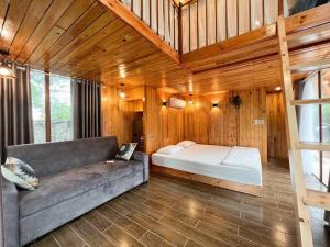 a living room with a couch and a bed at Căn Hana ( Moon Villa Sóc Sơn) in Hanoi